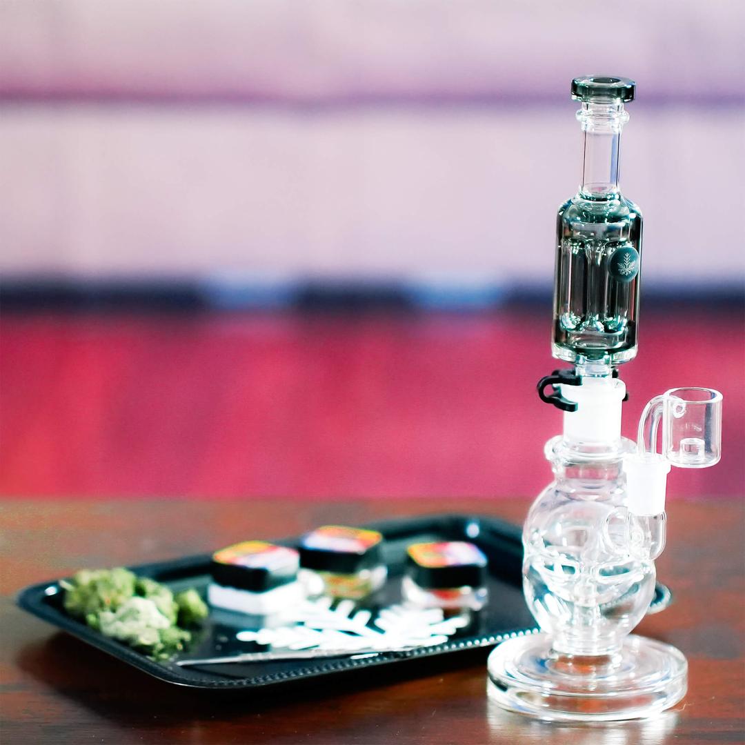 Freeze Pipe Mini Dab Rig displayed on tray — premium borosilicate glass and chilled vapor technology.